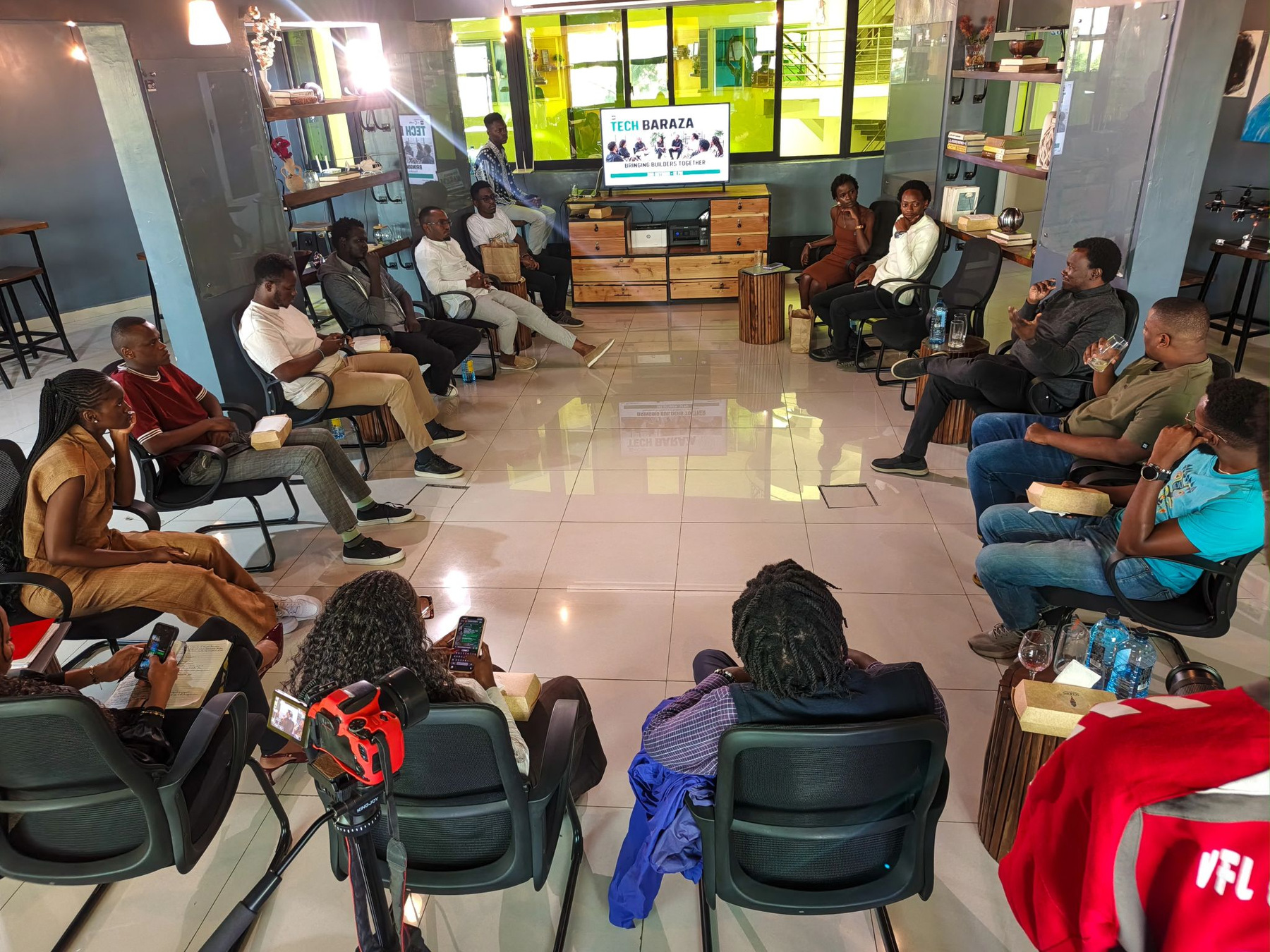 Builders and founders seated in a circle in a bright workroom
