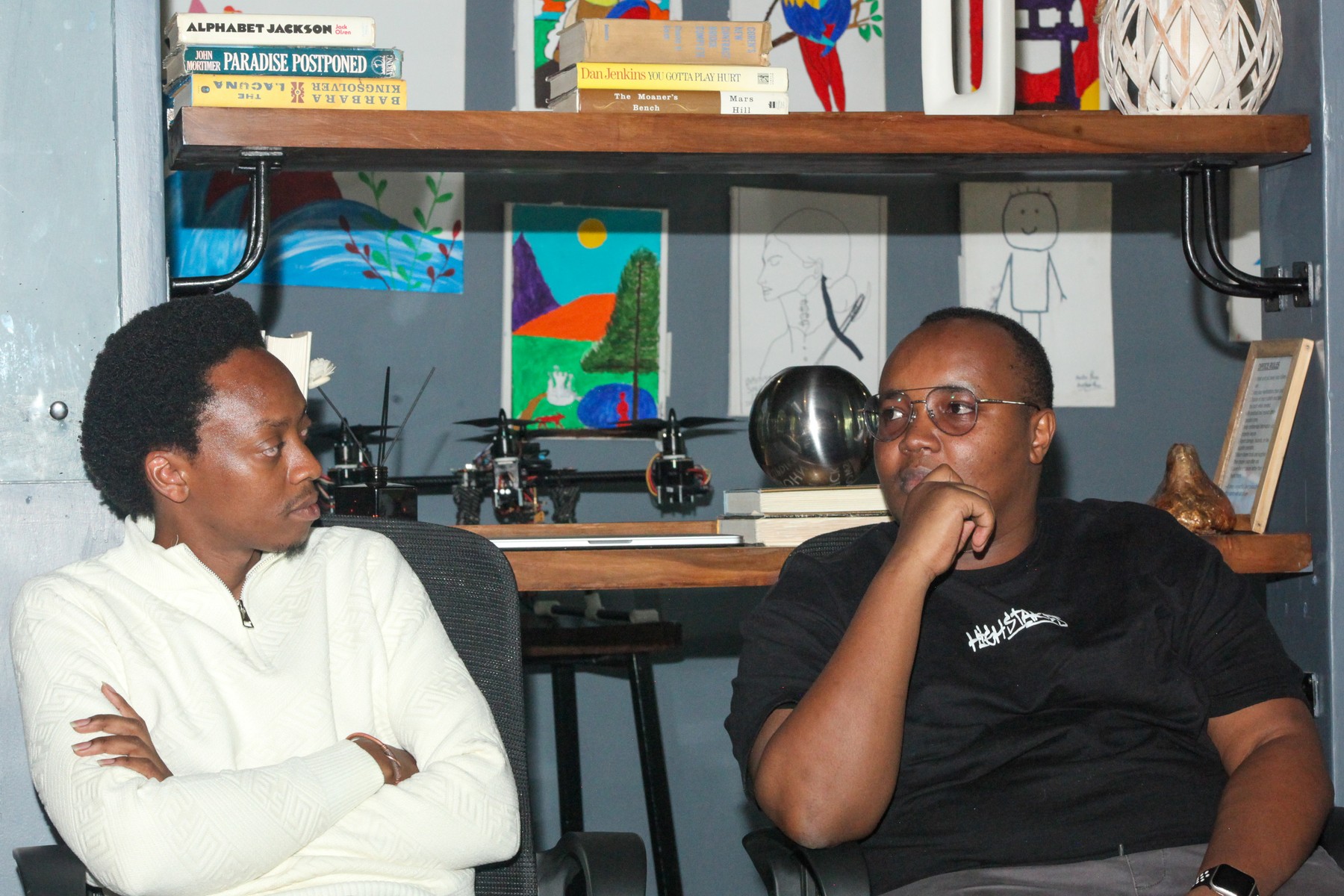 Two men listening side by side