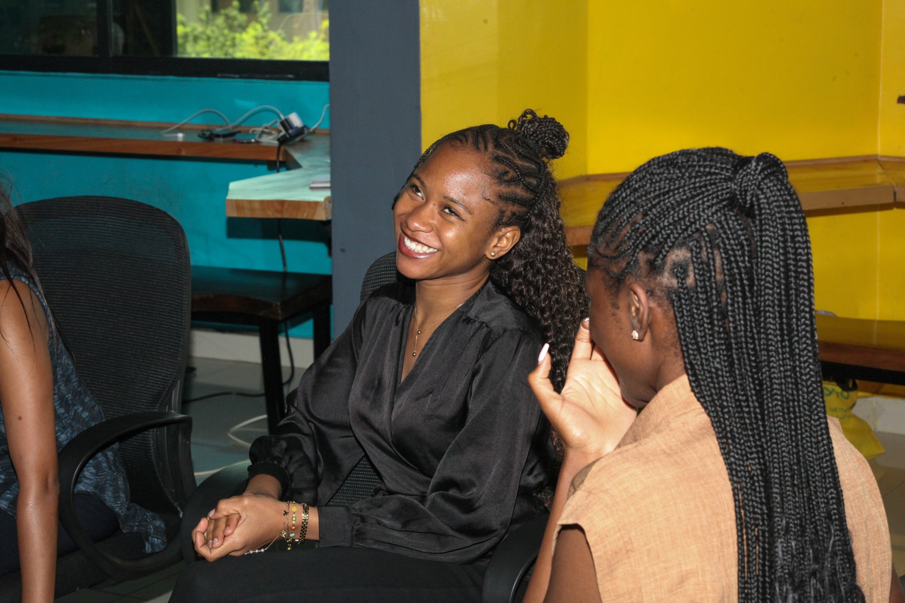 Two women smiling during a conversation