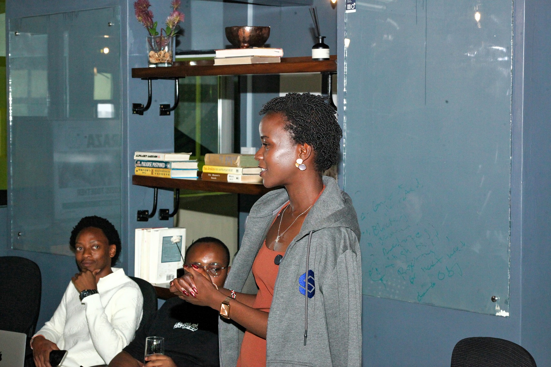 A woman speaking to people seated nearby