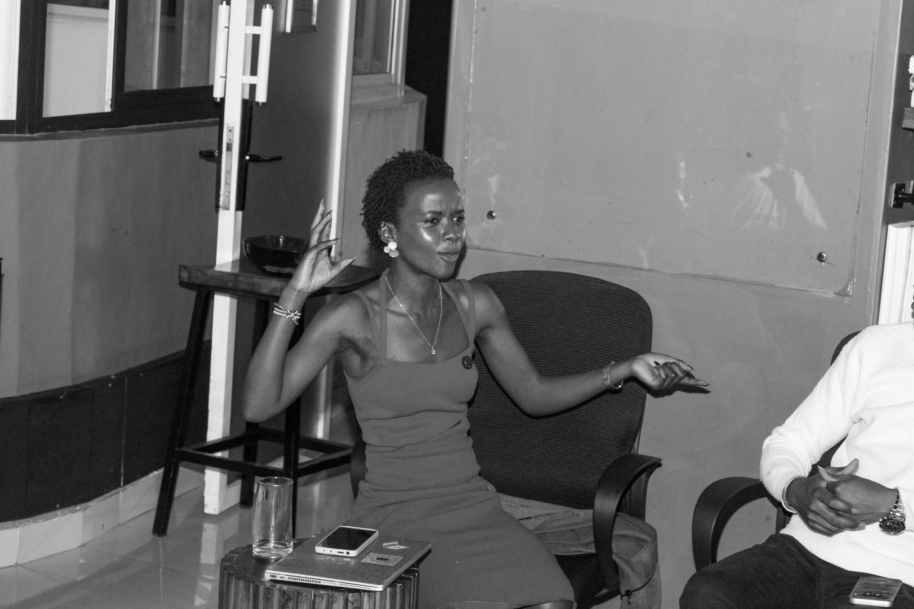 A woman speaking from her seat during a discussion